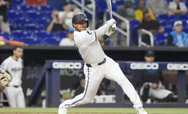 Miami Marlins Dane Myers hits a single to bring in two runs during the eighth inning of a baseball game against the Colorado Rockies, Wednesday, May 1, 2024, in Miami. (AP Photo/Marta Lavandier)