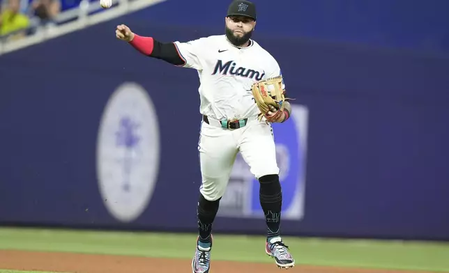 Miami Marlins third baseman Emmanuel Rivera throws to first base for an out during the seventh inning of a baseball game against the Colorado Rockies, Wednesday, May 1, 2024, in Miami. (AP Photo/Marta Lavandier)