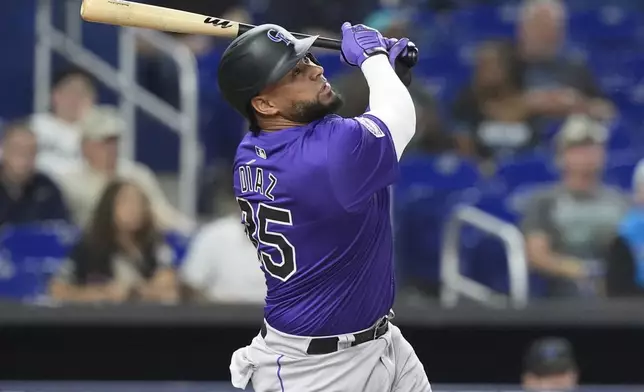 Colorado Rockies' Elias Díaz (35) hits a single to right field during the first inning of a baseball game against the Miami Marlins, Wednesday, May 1, 2024, in Miami. (AP Photo/Marta Lavandier)