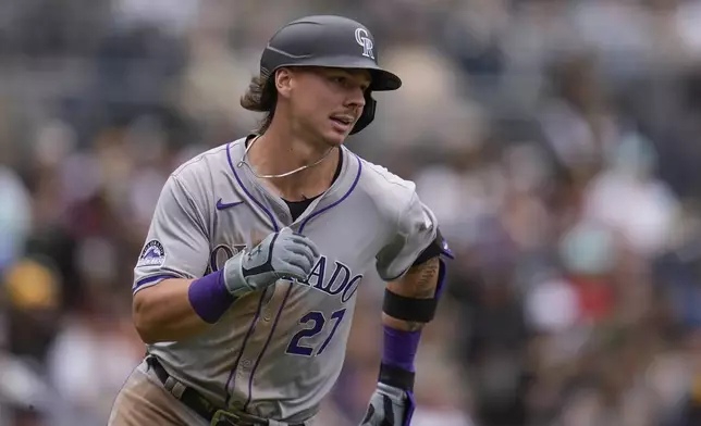 Colorado Rockies' Jordan Beck runs to first base after hitting an RBI single during the eighth inning of a baseball game against the San Diego Padres, Wednesday, May 15, 2024, in San Diego. (AP Photo/Gregory Bull)