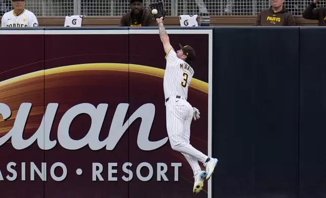 San Diego Padres center fielder Jackson Merrill makes a catch at the wall for the out on Colorado Rockies' Brendan Rodgers during the ninth inning of a baseball game, Wednesday, May 15, 2024, in San Diego. (AP Photo/Gregory Bull)