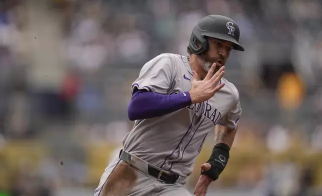 Colorado Rockies' Jake Cave runs on his way to scoring from second base off a two-RBI double by Jordan Beck during the second inning of a baseball game against the San Diego Padres, Wednesday, May 15, 2024, in San Diego. (AP Photo/Gregory Bull)