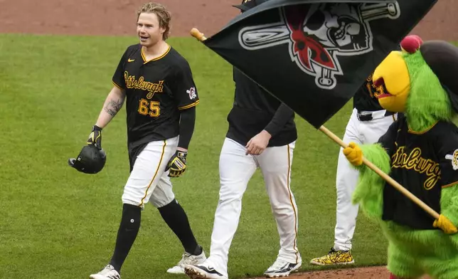 Pittsburgh Pirates' Jack Suwinski (65) walks off the field after driving in the winning run with a walkoff single off Colorado Rockies relief pitcher Nick Mears during the ninth inning of a baseball game in Pittsburgh, Saturday, May 4, 2024. (AP Photo/Gene J. Puskar)