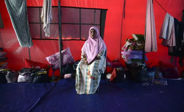 Fatima Khatun, a Rohingya survivor of a capsized refugee boat, poses for a photograph inside her tent in Meulaboh, Indonesia, on Thursday, April 4, 2024. Fatima was among 75 people rescued in March from atop the overturned hull of the boat. Dozens of others, including Fatima's 8-year-old daughter, died. (AP Photo/Reza Saifullah)