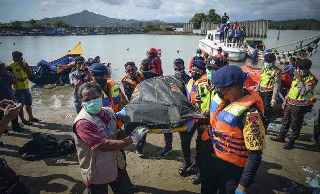 Rescuers carry the body of a Rohingya refugee recovered from the sea off Meulaboh, Indonesia, on Saturday, March 23, 2024. The bodies of 12 women and three children were recovered following the capsize of a boat that was carrying around 140 Rohingya refugees, according to the United Nations High Commissioner for Refugees. Sixty-seven people were killed in the disaster. (AP Photo/Reza Saifullah)