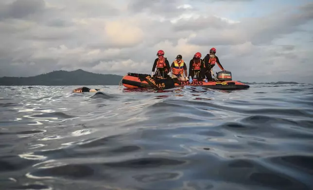 Rescuers recover the body of a Rohingya refugee from the waters off Meulaboh, Indonesia, on Saturday, March 23, 2024. The bodies of 12 women and three children were recovered following the capsize of a boat that was carrying around 140 Rohingya refugees, according to the United Nations High Commissioner for Refugees. Sixty-seven people were killed in the disaster. (AP Photo/Reza Saifullah)