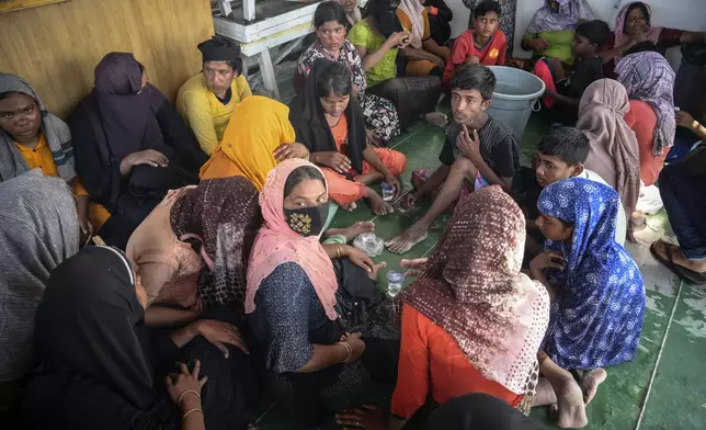 Rohingya refugees rest on the deck of a National Search and Rescue Agency ship, after being rescued from their capsized boat off West Aceh, Indonesia, on Thursday, March 21, 2024. The wooden fishing boat carried about 140 Rohingya refugees, but only 75 people were rescued. In interviews with The Associated Press, eight of the survivors described abuses on board the fishing boat. (AP Photo/Reza Saifullah)