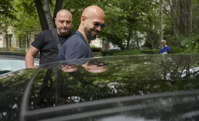 Andrew Tate smiles as he leaves the Bucharest Tribunal in Bucharest, Romania, Wednesday, May 8, 2024. A court in Romania's capital ruled on April 26, that a trial could start but did not set a date for the trial to begin in the case of influencer Andrew Tate, who is charged with human trafficking, rape and forming a criminal gang to sexually exploit women. (AP Photo/Vadim Ghirda)