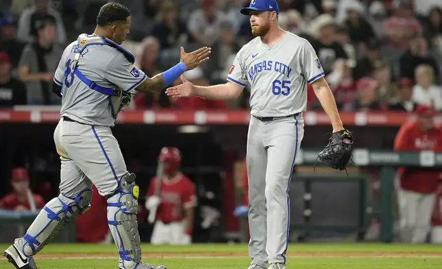 Kansas City Royals catcher Salvador Perez, left, and relief pitcher Matt Sauer congratulate each other after the Royals defeated the Los Angeles Angels 10-4 in a baseball game Thursday, May 9, 2024, in Anaheim, Calif. (AP Photo/Mark J. Terrill)