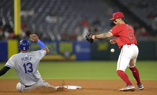 Kansas City Royals' Salvador Perez, left, is forced out at second as Los Angeles Angels shortstop Zach Neto drops the ball and is unable to throw out Michael Massey at first during the seventh inning of a baseball game Thursday, May 9, 2024, in Anaheim, Calif. (AP Photo/Mark J. Terrill)