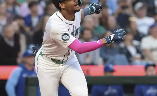 Seattle Mariners' Julio Rodríguez watches a single against the Kansas City Royals during the sixth inning of a baseball game Tuesday, May 14, 2024, in Seattle. (AP Photo/Jason Redmond)