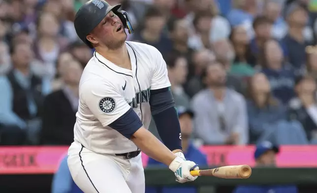 Seattle Mariners' Ty France reacts after popping out during the sixth inning of the team's baseball game against the Kansas City Royals, Tuesday, May 14, 2024, in Seattle. (AP Photo/Jason Redmond)