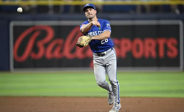 Kansas City Royals second base Adam Frazier (26) throws to first base, getting the out after fielding a ground ball from Tampa Bay Rays' José Caballero during the sixth inning of a baseball game, Saturday, May 25, 2024, in St. Petersburg, Fla. (AP Photo/Phelan M. Ebenhack)