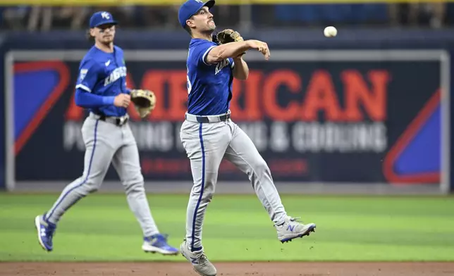 Kansas City Royals second base Adam Frazier (26) gets the out at first base after fielding a ground ball by Tampa Bay Rays outfielder Richie Palacios during the first inning of a baseball game, Saturday, May 25, 2024, in St. Petersburg, Fla. (AP Photo/Phelan M. Ebenhack)