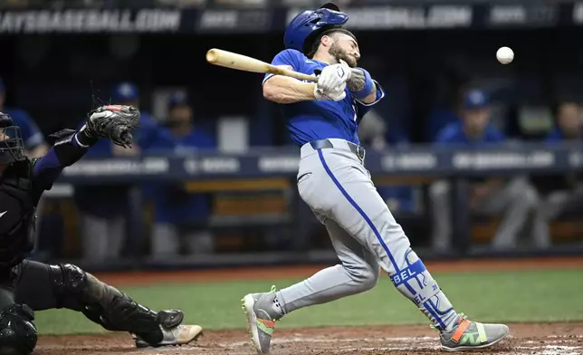 Kansas City Royals' Kyle Isbel, right, fouls a pitch off his face during the seventh inning of a baseball game against the Tampa Bay Rays, Saturday, May 25, 2024, in St. Petersburg, Fla. (AP Photo/Phelan M. Ebenhack)