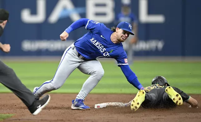 Tampa Bay Rays' Jose Siri, right, is tagged out by Kansas City Royals shortstop Bobby Witt Jr., center, while trying to steal second base during the third inning of a baseball game, Saturday, May 25, 2024, in St. Petersburg, Fla. (AP Photo/Phelan M. Ebenhack)