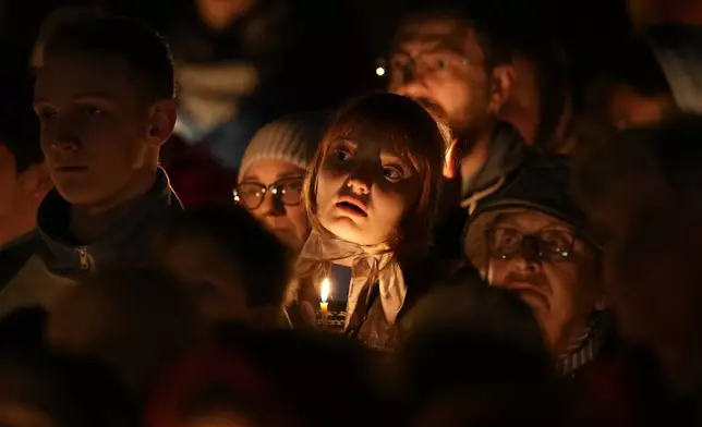 Orthodox believers walk with candles around a church during Orthodox Easter midnight service in St. Petersburg, Russia, Sunday, May 5, 2024. Eastern Orthodox churches observe the ancient Julian calendar and this year celebrate Orthodox Easter on May 5. (AP Photo/Dmitri Lovetsky)