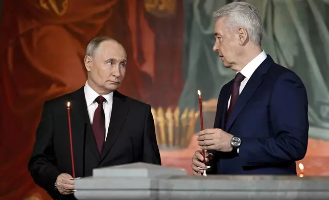 Russian President Vladimir Putin, left, and Moscow Mayor Sergei Sobyanin attend the Orthodox Easter service at the Cathedral of Christ the Saviour in Moscow, Russia, Sunday, May 5, 2024. (Pavel Bednyakov, Sputnik, Kremlin Pool Photo via AP)