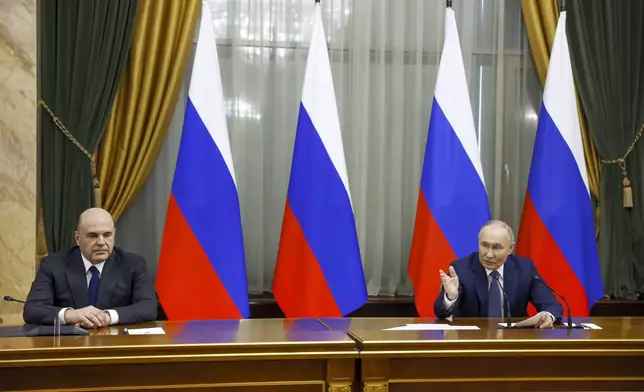 Russian President Vladimir Putin, right, and Russian Prime Minister Mikhail Mishustin attend a meeting with Cabinet members in Moscow, Russia, Monday, May 6, 2024. Putin thanked Cabinet ministers for their work ahead of his inauguration Tuesday. (Dmitry Astakhov, Sputnik, Government Pool Photo via AP)