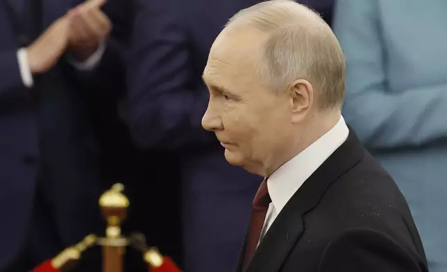 Vladimir Putin walks to take his oath as Russian president during an inauguration ceremony in the Grand Kremlin Palace in Moscow, Russia, Tuesday, May 7, 2024. (Maxim Shemetov/Pool Photo via AP)