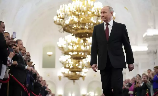 Vladimir Putin walks to take his oath as Russian president during an inauguration ceremony in the St. George Hall of the Grand Kremlin Palace in Moscow, Russia, Tuesday, May 7, 2024. Putin began his fifth term at a glittering Kremlin inauguration Tuesday, embarking on another six years as leader of Russia after destroying his political opponents, launching a devastating war in Ukraine and concentrating all power in his hands. (AP Photo/Alexander Zemlianichenko, Pool)