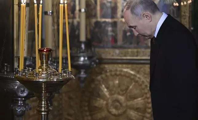 Russian President Vladimir Putin attends a prayer service following an inauguration ceremony at the Kremlin's Annunciation Cathedral in Moscow, Russia, Tuesday, May 7, 2024. (Alexey Maishev, Sputnik, Kremlin Pool Photo via AP)