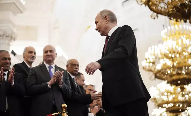 Vladimir Putin walks to take his oath as Russian president during an inauguration ceremony in the Grand Kremlin Palace in Moscow, Russia, Tuesday, May 7, 2024. (AP Photo/Alexander Zemlianichenko, Pool)