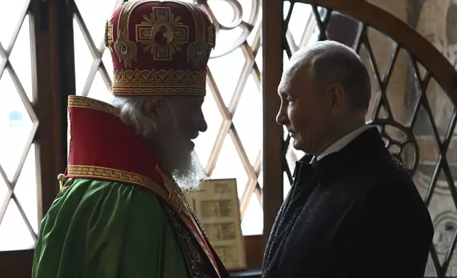 Russian President Vladimir Putin, right, and Patriarch Kirill of Moscow and all Russia talk during a prayer service following an inauguration ceremony at the Kremlin's Annunciation Cathedral in Moscow, Russia, Tuesday, May 7, 2024. (Alexey Maishev, Sputnik, Kremlin Pool Photo via AP)