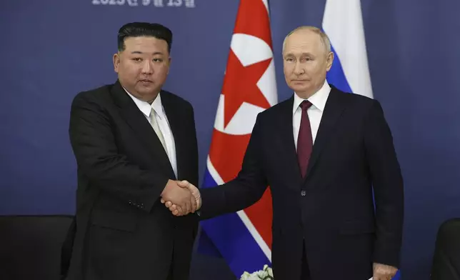 FILE - Russian President Vladimir Putin, right, and North Korean leader Kim Jong Un shake hands during a meeting at the Vostochny cosmodrome outside the city of Tsiolkovsky, about 200 kilometers (125 miles) from the city of Blagoveshchensk in the far eastern Amur region of Russia on Sept. 13, 2023. Russia has been heavily sanctioned by the West over Ukraine and is turning other regimes like China and North Korea for support. (Vladimir Smirnov/Sputnik Kremlin Pool Photo via AP, File)