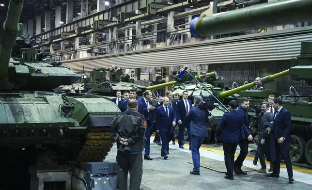 FILE - Russian President Vladimir Putin, center, visits the Uralvagonzavod factory in Nizhny Tagil, Russia, on Thursday, Feb. 15, 2024. Military industries have become a key engine of Russia's economic growth, with defense plants churning out missiles, tanks and ammunition. (Ramil Sitdikov, Sputnik, Kremlin Pool Photo via AP, File)