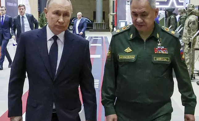 FILE - Russian President Vladimir Putin, left, and Russian Defense Minister Sergei Shoigu arrive for a meeting with the military brass in Moscow, Russia, Tuesday, Dec. 19, 2023. A Shoigu deputy was detained last month on charges of bribery amid reports of rampant corruption. (Mikhail Klimentyev, Sputnik, Kremlin Pool Photo via AP, File)