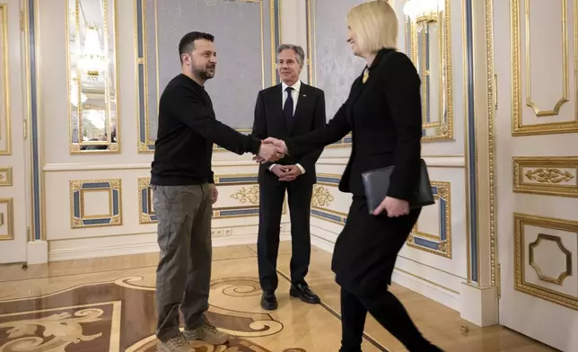 U.S. Secretary of State Antony Blinken, center, watches Ukraine's President Volodymyr Zelenskyy, left, greets U.S. Ambassador to Ukraine Bridget Brink, right, prior to their meeting in Kyiv Tuesday, May 14, 2024. Blinken arrived in Kyiv on Tuesday in an unannounced diplomatic mission to reassure Ukraine that it has American support as it struggles to defend against increasingly intense Russian attacks. (Brendan Smialowski/Pool Photo via AP)