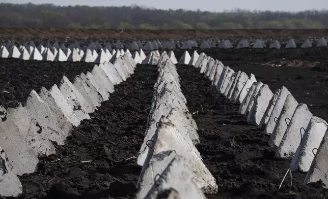 Anti-tank systems known as “dragon teeth” are seen in the field close to the Russian border in the Kharkiv region, Ukraine, on Wednesday, April 17, 2024. (AP Photo/Evgeniy Maloletka)