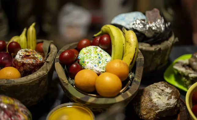 Food are gathered to be blessed during a Christian Orthodox Easter religious service at the 72nd Separate Mechanized Brigade compound, in Dnipropetrovsk region, Ukraine, early Sunday, May 5, 2024. (AP Photo/Francisco Seco)