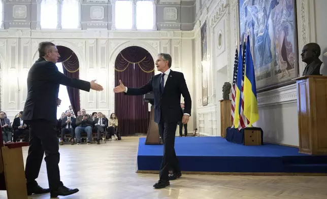 U.S. Secretary of State Antony Blinken, right, leaves the stage after addressing students and and professors in Igor Sikorsky Polytechnic Institute in Kyiv, Ukraine, Tuesday, May 14, 2024. Blinken arrived in Kyiv on Tuesday in an unannounced diplomatic mission to reassure Ukraine that it has American support as it struggles to defend against increasingly intense Russian attacks. (Brendan Smialowski/Pool via AP)