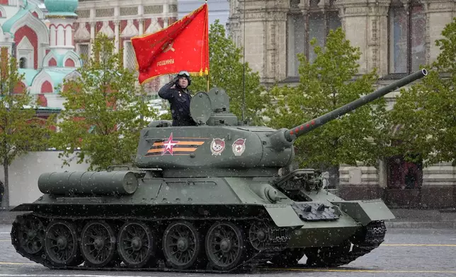 A legendary Soviet era T-34 tank with a red flag atop rolls during the Victory Day military parade in Moscow, Russia, Thursday, May 9, 2024, marking the 79th anniversary of the end of World War II. (AP Photo/Alexander Zemlianichenko)