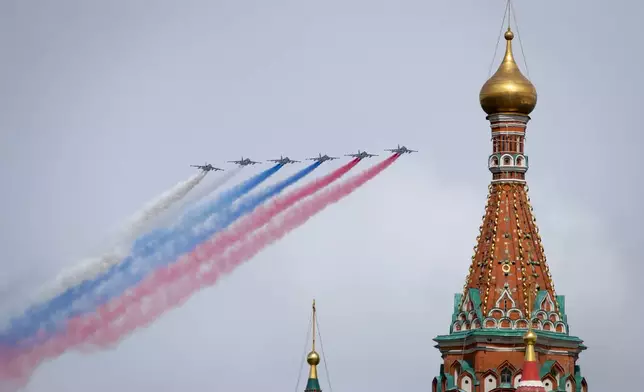Russian Air Force Su-25 jets fly over Red Square leaving trails of smoke in the colours of the Russian national flag during the Victory Day military parade in Moscow, Russia, Thursday, May 9, 2024, marking the 79th anniversary of the end of World War II. (AP Photo)