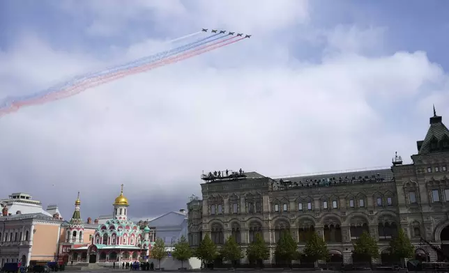 Russian Air Force Su-25 jets fly over Red Square leaving trails of smoke in colours of the national flag during the Victory Day military parade in Moscow, Russia, Thursday, May 9, 2024, marking the 79th anniversary of the end of World War II. (AP Photo/Alexander Zemlianichenko)