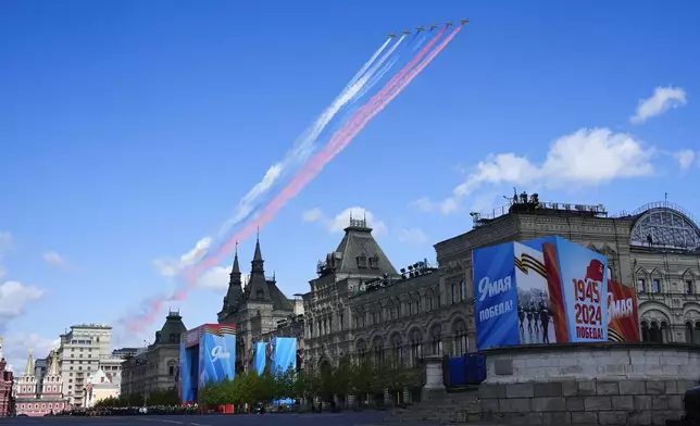 Russian military planes fly over Red Square leaving trails of smoke in colors of the national flag during the Victory Day military parade dress rehearsal at the Red Square in Moscow, Russia, Sunday, May 5, 2024. The parade will take place at Moscow's Red Square on May 9 to celebrate 79 years of the victory in WWII. (AP Photo/Alexander Zemlianichenko)