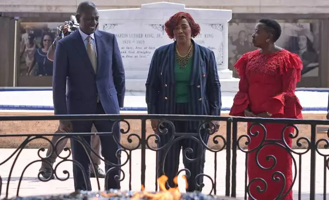 Kenya President William Ruto and first lady Rachel Ruto, right, pause at the Eternal Flame with Bernice King, center, daughter of Martin Luther King Jr., during a visit to the King Center Monday, May 20, 2024, in Atlanta. The gravesite of King and his wife Coretta Scott King are in the background. (AP Photo/John Bazemore)