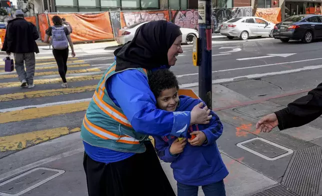 Tatiana Alabsi, left, hugs her nephew Adam Khalid as she roams the Tenderloin neighborhood Wednesday, March 20, 2024, in San Francisco. (AP Photo/Godofredo A. Vásquez)