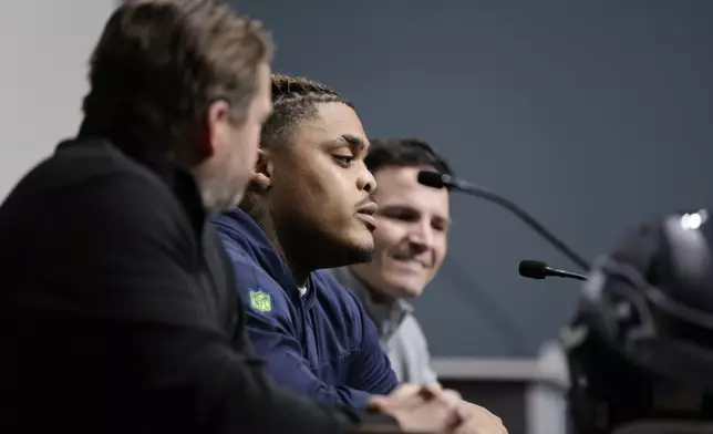 Seattle Seahawks 2024 first round draft pick, Byron Murphy II, center, speaks as he is introduced by general manager John Schneider, left, and head coach Mike Macdonald, right, during a news conference at the NFL team's headquarters, Thursday, May 2, 2024, in Renton, Wash. (AP Photo/John Froschauer)