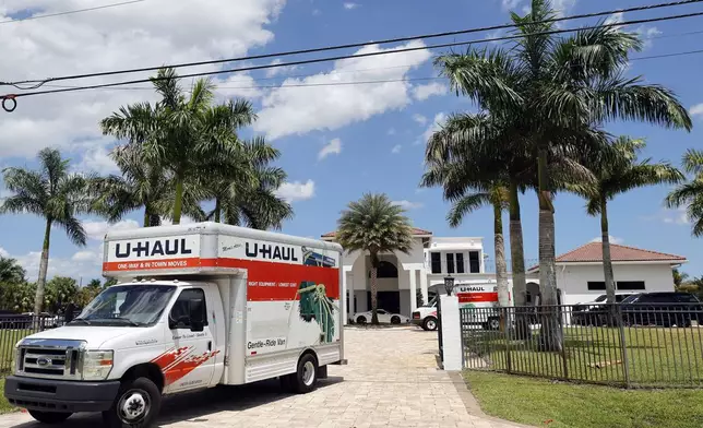 A U-Haul is seen leaving Sean Kingston's Southwest Ranches, Fla., home Thursday, May 23, 2024. A SWAT team raided rapper Kingston's rented mansion on Thursday, and arrested his mother on fraud and theft charges that an attorney says stems partly from the installation of a massive TV at the home. (Amy Beth Bennett/South Florida Sun-Sentinel via AP)