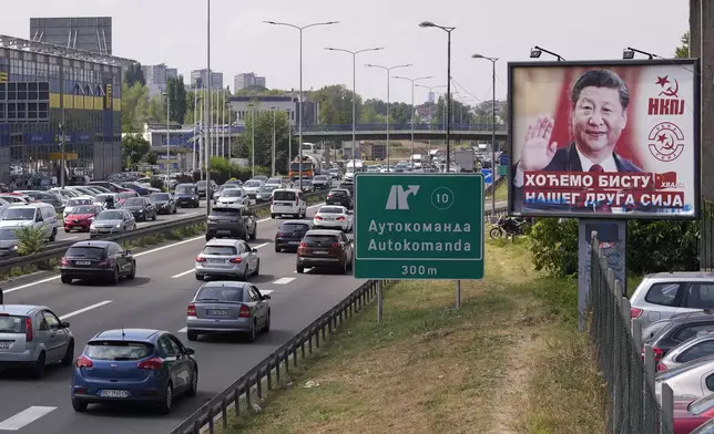 FILE - Cars move by a billboard showing China's President Xi Jinping, reading: "We want a statue of our friend Xi," and "Thanks," in Belgrade, Serbia, on Aug. 26, 2021. Chinese leader Xi Jinping's visit to European ally Serbia on Tuesday, May 7, 2024, falls on a symbolic date: the 25th anniversary of the bombing of the Chinese Embassy in Belgrade during NATO's air war over Kosovo. (AP Photo/Darko Vojinovic, File)