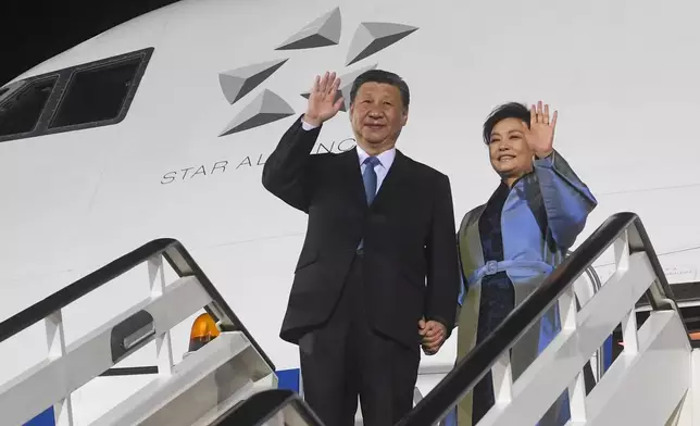 In this photo provided by the Serbian Presidential Press Service, Chinese President Xi Jinping, left, and his wife Peng Liyuan wave during a welcome ceremony upon arrival at the Nikola Tesla airport in Belgrade, Serbia, Tuesday, May 7, 2024. (Serbian Presidential Press Service via AP)