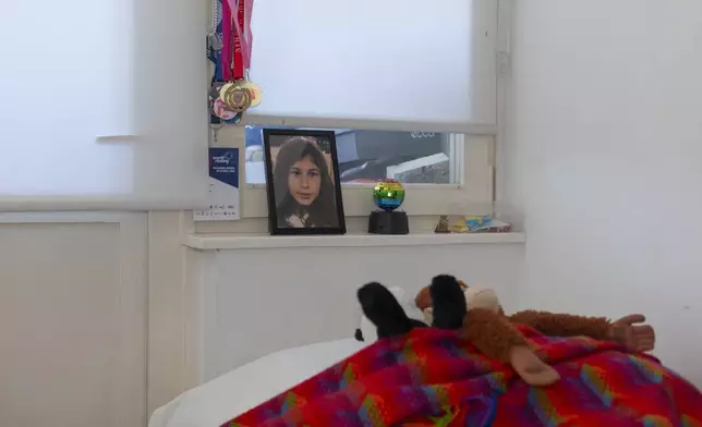 In this photo taken on Saturday, April 27, 2024, a framed photograph of Ana Bozovic, a slain elementary school student, sits above her bed in Belgrade, Serbia. The 11-year-old Ana Bozovic had just arrived to her school in central Belgrade last year when another pupil, 13 at the time, came in and opened fire at anyone standing in his way. A total of 10 people were killed. (AP Photo/Marko Drobnjakovic)