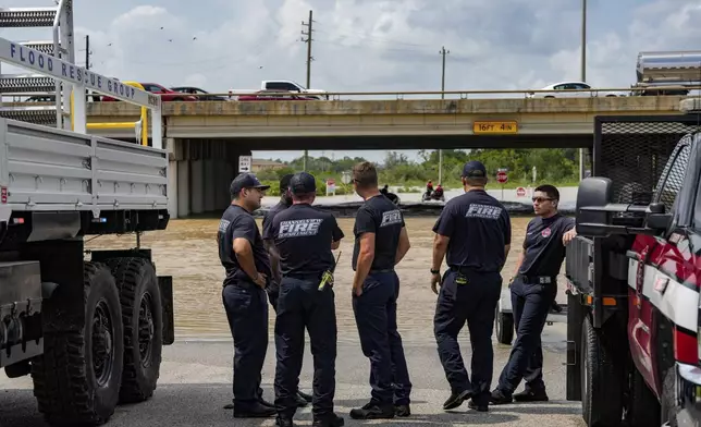 Channelview Fire Department and sheriffs get ready to help evacuate the area due to severe flooding, Saturday, May 4, 2024, in Channelview, Texas. (Raquel Natalicchio/Houston Chronicle via AP)