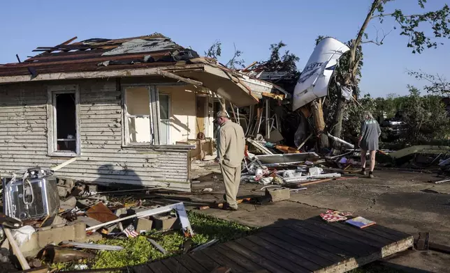 Tim and Joy King looks at their house that was destroyed by a tornado Tuesday, May 7, 2024 in Barnsdall, Okla. (Mike Simons/Tulsa World via AP)