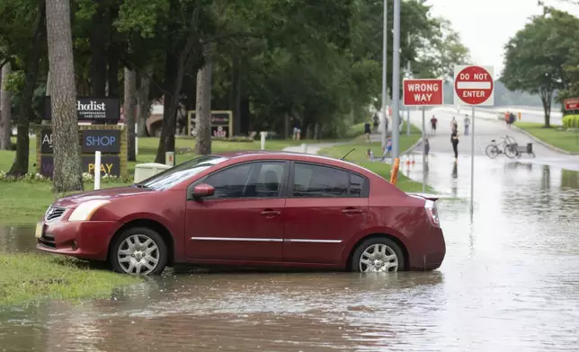 A stranded care is seen near the bridge over Lake Houston along West Lake Houston Parkway after it was closed due to high water on either side of the thoroughfare, Saturday, May 4, 2024, in Kingwood, Texas. (Jason Fochtman/Houston Chronicle via AP)