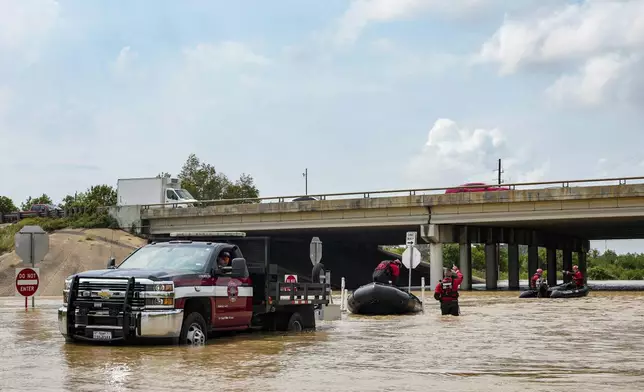 Channelview Fire Department and sheriffs get ready to help evacuate the area due to severe flooding, Saturday, May 4, 2024, in Channelview, Texas. (Raquel Natalicchio/Houston Chronicle via AP)